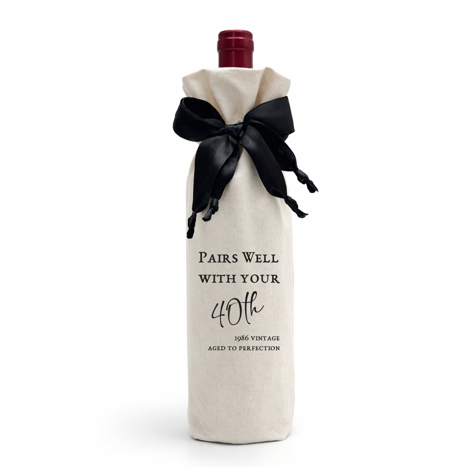 A luxury gift bag, made from calico cotton tied with a black satin bow. The bag reads: "Pairs Well with Your 40th — 1986 Vintage — Aged to Perfection." Made in SA.
